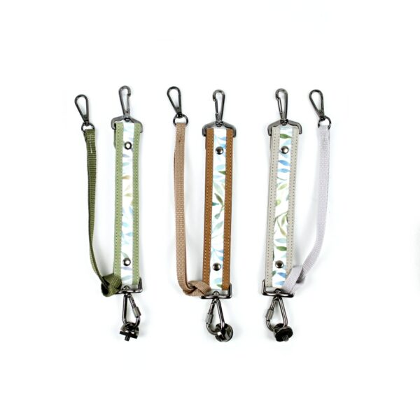 The photo shows the double sling camera strap fasteners in three colors